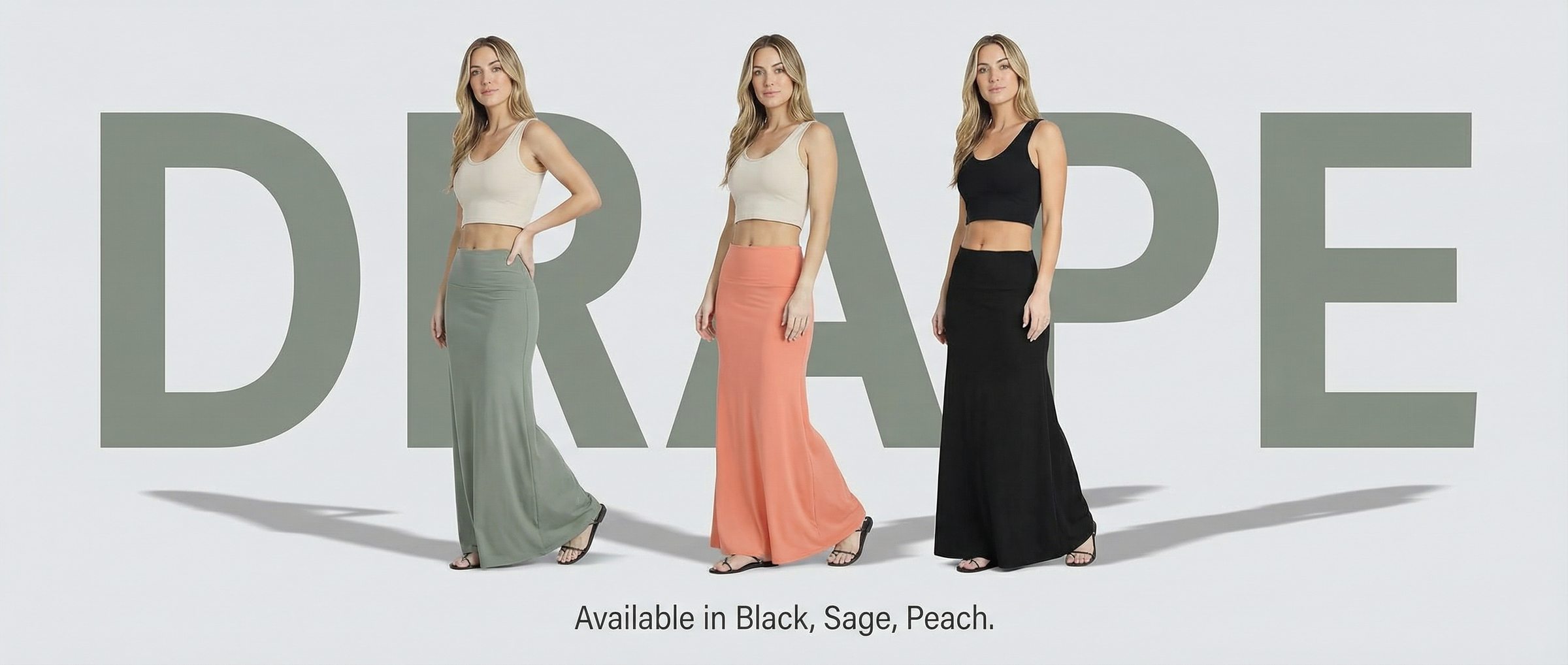 图片展示了服装套图“DRAPE”的生成效果。画面中有三位女性模特，分别穿着黑色、浅绿色和橙色的长裙，搭配白色上衣，站在灰色背景前。背景中大写英文字母“DRAPE”以浅灰色呈现。底部文字说明“Available in Black, Sage, Peach.”，表明该款服装有黑色、浅绿色和橙色三种颜色可选。此图与文档中介绍服装套图版式模版使用技巧及生成效果展示的内容相关，直观呈现了生成的服装展示效果。